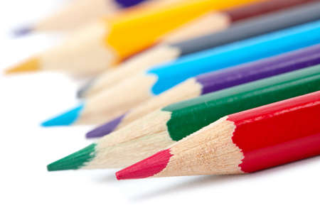 Assortment of coloured pencils with shadow on white background. Shallow depth of fieldの写真素材