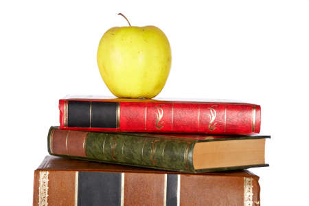 Apple on the pile of books isolated isolated on white backgroundの写真素材