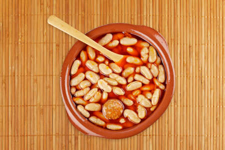 Baked beans in tomato sauce isolated on a bamboo mat. Shallow depth of fieldの写真素材
