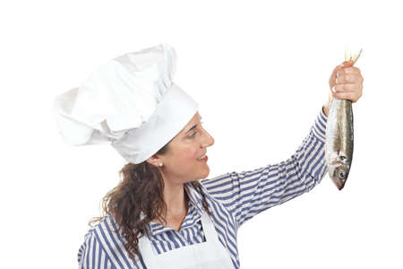 Cook woman holding a fresh fish isolated on white backgroundの写真素材