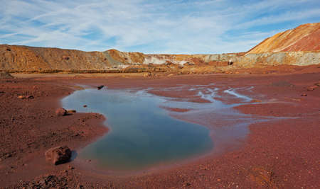 Hill over the blue sky and the little lakeの写真素材
