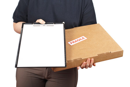 Courier woman delivering a parcel fragile and holding a clipboard for a signature