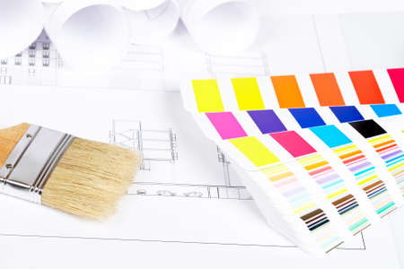 A paintbrush and color guide over the house planの写真素材