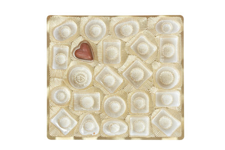 Sweet tasty chocolate candie in a gold box isolated