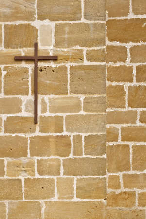 Cross sign on a brick wallの写真素材