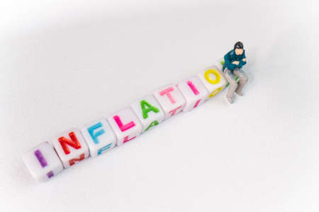 background Inflation toy cubes and miniature manの写真素材