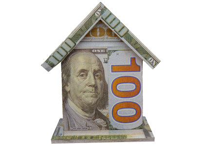 A small house made out of hundred dollar bills, concept of inflation, high cost of interest rates, housing, unaffordabilityの写真素材