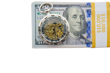 Stack of 10.000 in hundred dollar bills with a modern pocket watch placed on top, white backgroundの写真素材