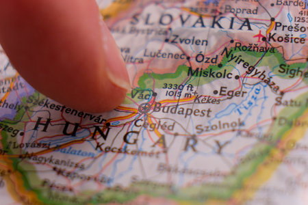 Finger pointing to Budapest, Hungary on colorful map with selective focus, shallow depth of field, background blurの写真素材