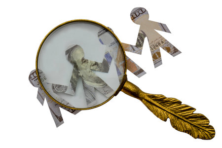 Magnifying glass viewing paper dolls cut out of hundred dollar bills of bankers with linked hands, isolated on white backgroundの写真素材