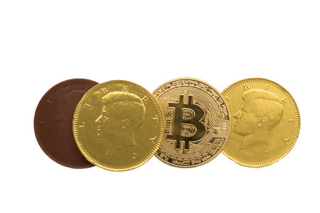Arrangement of candy coins and bitcoin on a white backgroundの写真素材