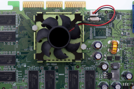 Close up of a graphics card, circuit board with cooling fan, circuits, wiringの写真素材