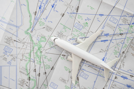 Close up of a miniature airplane on an FAA aviation sectional navigation map showing Oakland airport approachの写真素材
