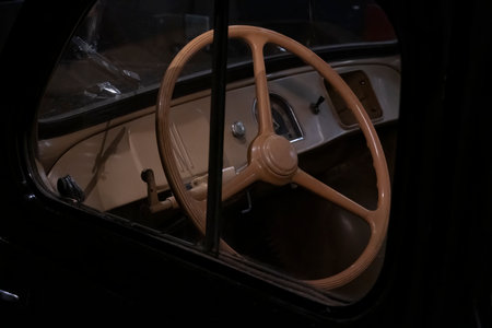 View inside of a vintage car showing the dashboard and steering wheel.の写真素材