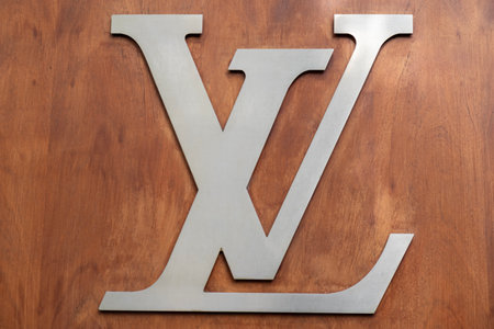 4 May 2023 Paris, France. Close up of Louis Vuitton signature brand logo on a wood paneled wall.のeditorial素材