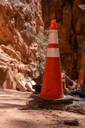 Orange caution cone on Zion park trail construction