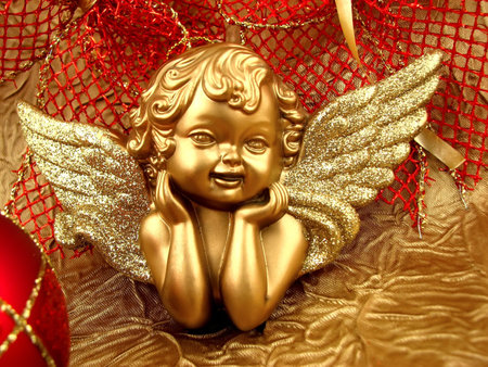 Gold Angel with red ribbon on backgroundの写真素材