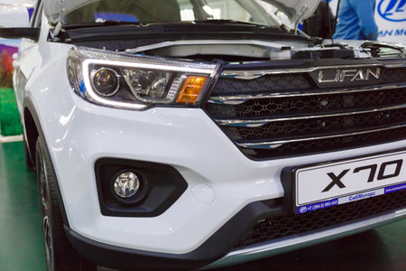 Handshake of two businessmen when selling a car in a motor show, close-up