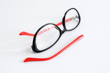 Broken glasses on white background. The concept of optics repair, vision impairment. Vision...