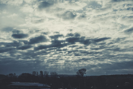 The suns rays through the clouds above the forest. Dark clouds at sunrise in Siberia. Siberian...