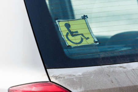 The owner's disability sign on the car window. Car of a person with a disability.の写真素材