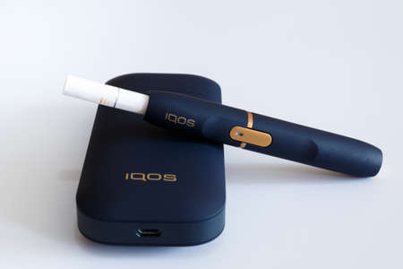 Novokuznetsk, Russia 21.02.2020 year. IQOS set for Smoking small cigarettes on a white background. Isolate. Editorialのeditorial素材