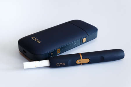 Novokuznetsk, Russia 21.02.2020 year. IQOS set for Smoking small cigarettes on a white background. Isolate. Editorialのeditorial素材