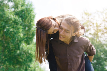 Loving multilingual couple on a walk in the Park. In love and very cheerful couple.