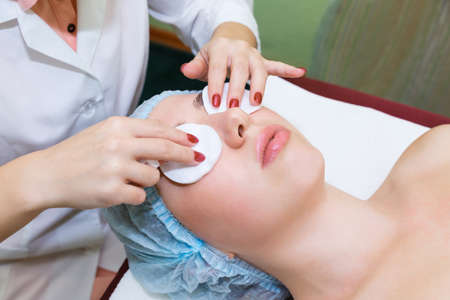 Young woman with clean healthy skin lies on a facial skin care procedure. Cosmetic care for the health of the skin of the face.の写真素材