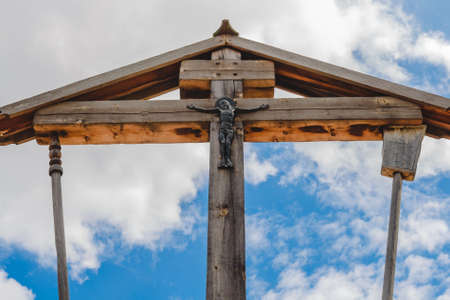 Wooden crucifixion of Jesus Christ on a background of blue sky with clouds.の写真素材