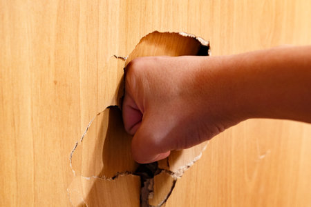 The concept of aggression, domestic violence or breaking through a wall of problems.の写真素材