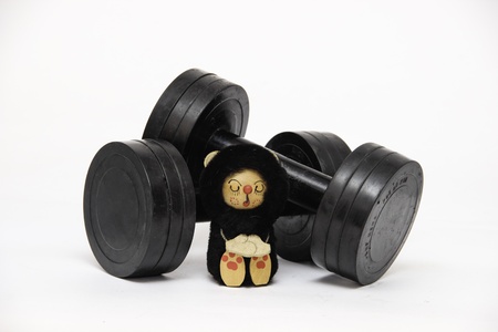Old dumbbells before them a meditating doll lieの写真素材
