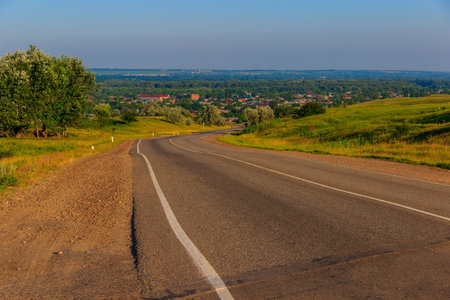 Asphalted, but the twisting road conducting down with the hill to the settlement. Krasnodar Krai,...