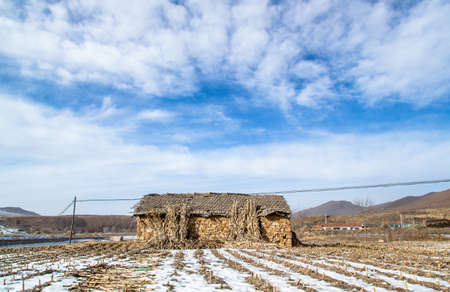 Traditional stone house with frozen farmlandのeditorial素材