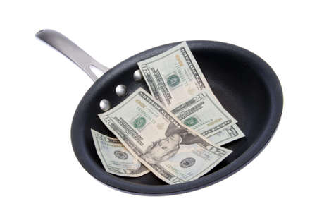 Money (dollar bills) in a Frying Pan to represent the cost of food, eating out, etc.の写真素材