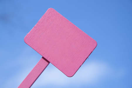 Bright pink sign on a blue sky background.  Blank for your message.  Climate Change, Global Warming, Nature, Outdoors, Gardening, Etc.の写真素材