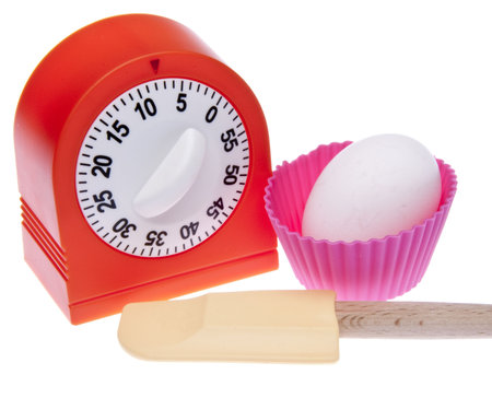 Kitchen Timer, spatula, cupcake wrapper and egg for cooking or baking themed image.  Isolated on...