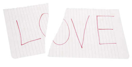 The word LOVE torn in half.  It is heartbreak.  Isolated on white with a clipping path.の写真素材