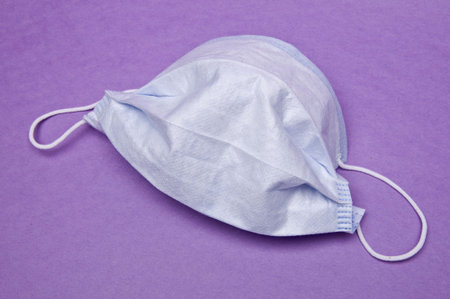 Surgical Mask on a Purple Background.