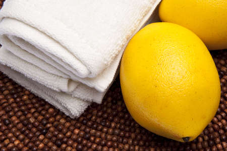 Fresh lemons are at the center of this spa related image.の写真素材