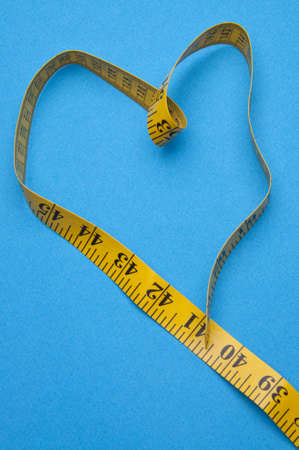 Heart Shaped Measuring Tape on a Vibrant Background.の写真素材