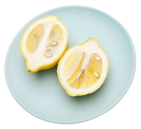 Vibrant lemon on a blue plateの写真素材