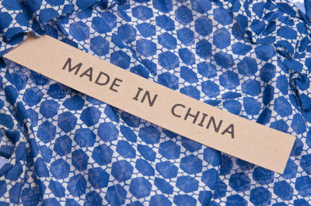Bright blue shirt with Made in China tag.の写真素材