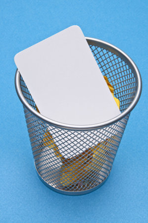 Business Card Tossed in the Trash on a Vibrant Blue Background
