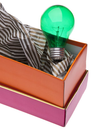 Green Lightbulb with Giftwrap Represents Ideas for Green Gift Giving.の写真素材