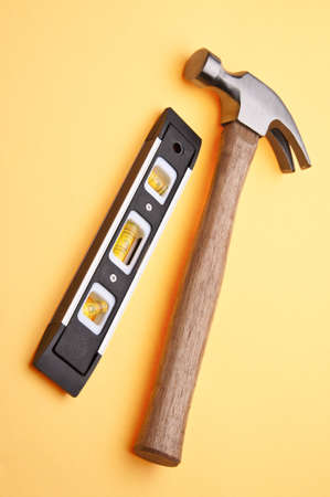 Home Improvement Scene.  Paintbrush and Level on Yellow.の写真素材