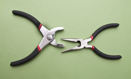 Home Improvement Scene.  Pliers on a Green Background.
