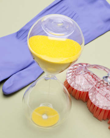 Hourglass and Cleaning Supplies for Time to Clean Theme.の写真素材