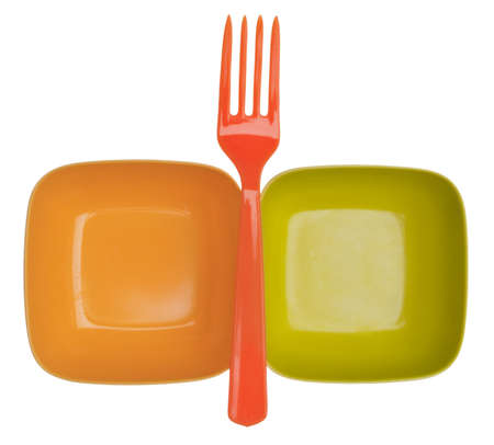 Two Vibrant Colored Empty Plastic Bowls Topped with a Bright Orange Plastic Fork.  Isolated on White の写真素材
