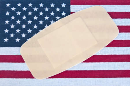 American Flag with Bandage for Concept of America Wounded.の写真素材